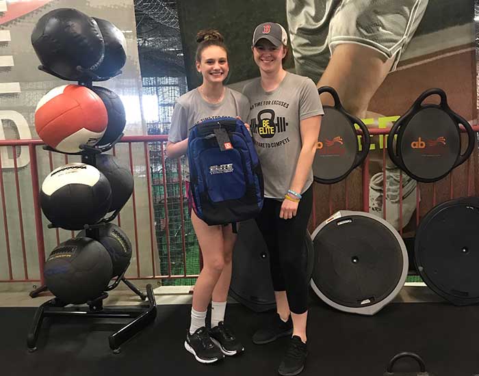 Dylan standing with a woman trainer