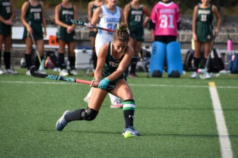 Kay Murphy playing field hockey