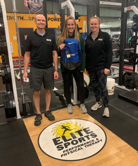 Girl receiving bag from trainers