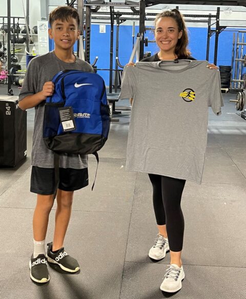 boy getting bag and tshirt from trainer