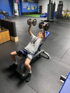 Boy doing DB chest press