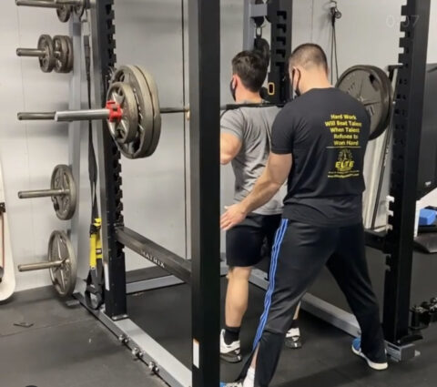 Boy doing weighted squats