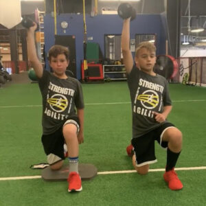 two kids lifting weights